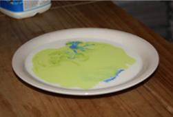 Add little drops of food colouring into the milk.