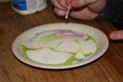 Touch the milk with washing up liquid.