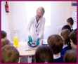 Young scientists look on as Claire demonstrates the 'Lilac Fire' experiment
